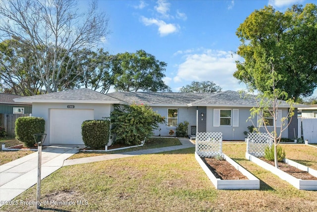 ranch-style home featuring a garage and a front lawn