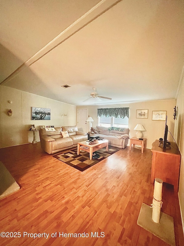 living room featuring ceiling fan and hardwood / wood-style flooring