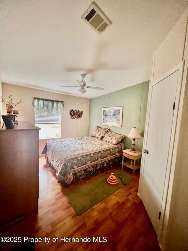 bedroom with hardwood / wood-style floors and ceiling fan