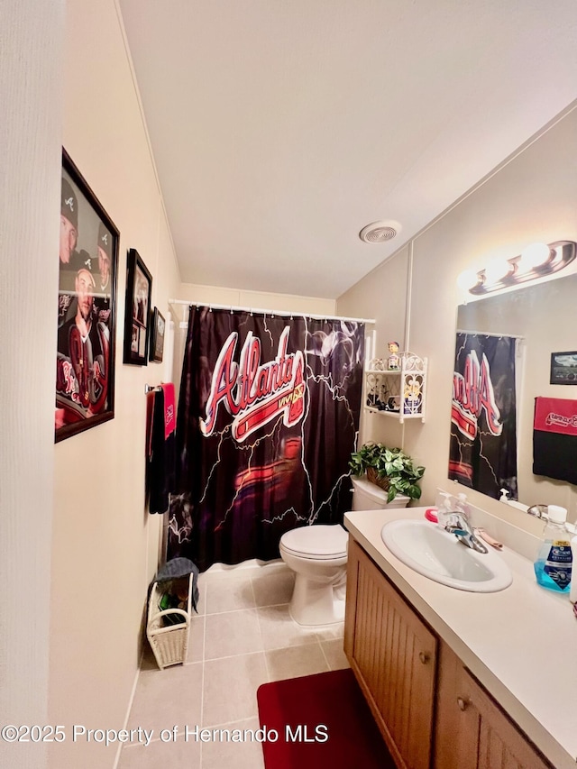 bathroom with tile patterned flooring, vanity, and toilet