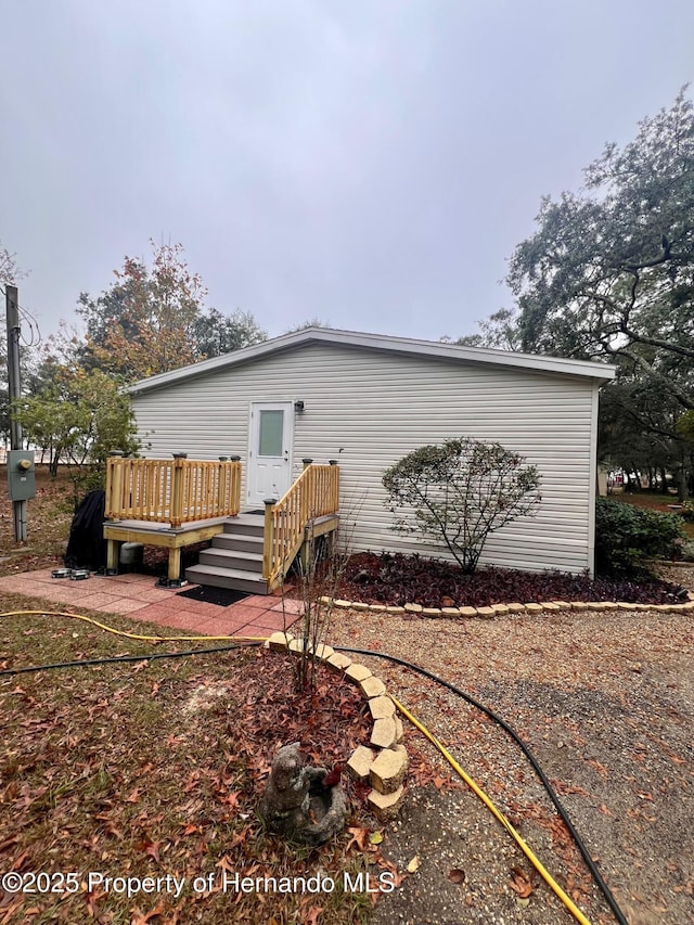 back of house featuring a wooden deck