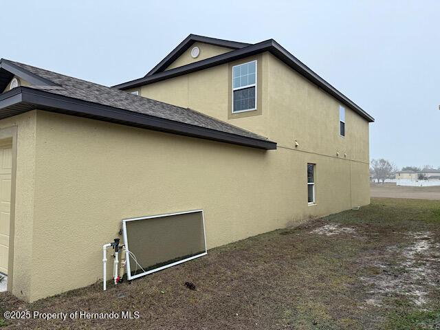 view of side of home with a garage