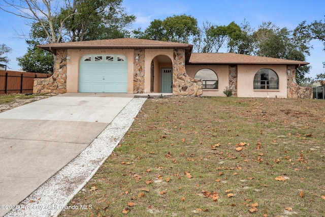 ranch-style house featuring a garage and a front lawn