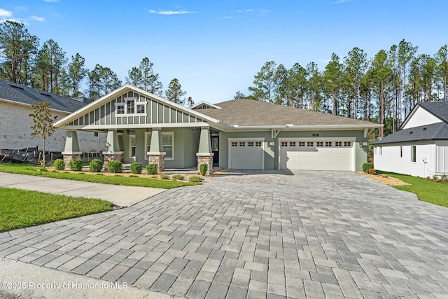 craftsman house featuring a porch and a garage