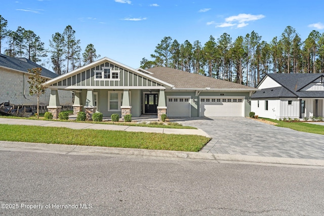 view of front of home with a porch and a garage