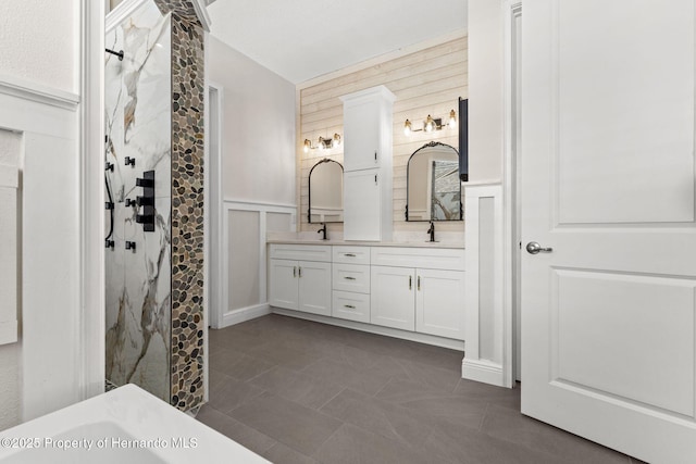 bathroom featuring tile patterned floors, vanity, and a shower