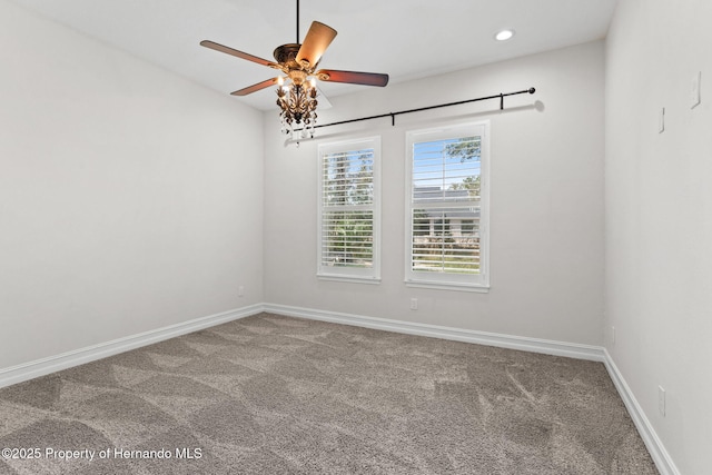 carpeted empty room featuring ceiling fan