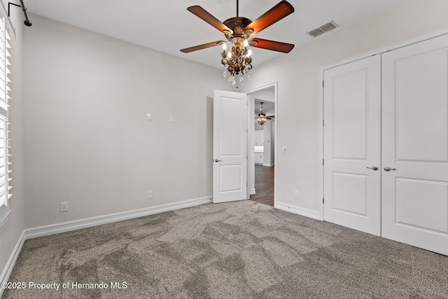 unfurnished bedroom with carpet, a closet, and ceiling fan