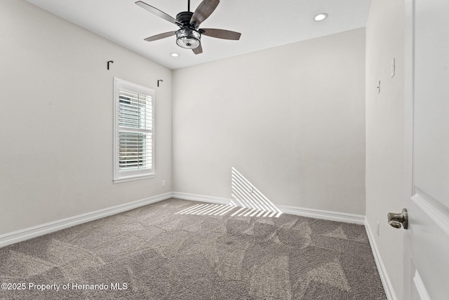 spare room featuring carpet flooring and ceiling fan