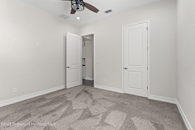 unfurnished bedroom with carpet floors and ceiling fan