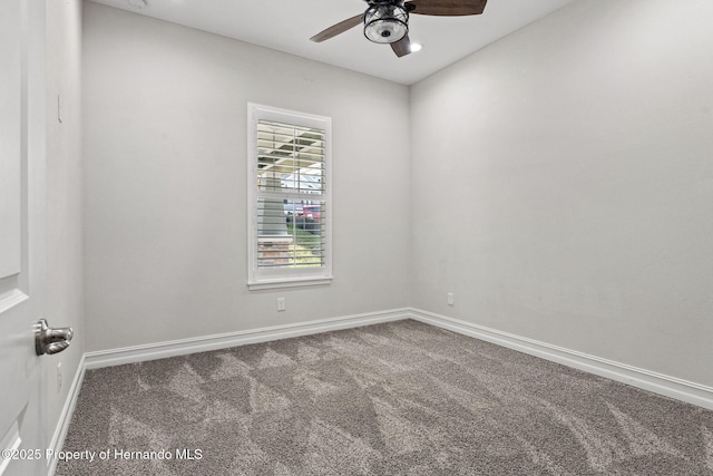 carpeted empty room featuring ceiling fan