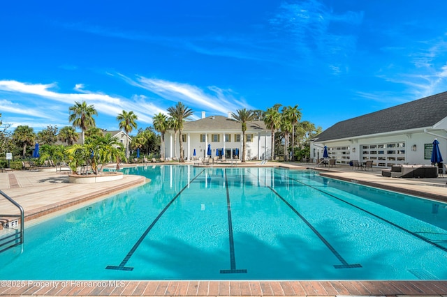 view of swimming pool with a patio area and an outdoor living space