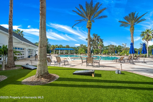 view of swimming pool with a lawn and a patio area