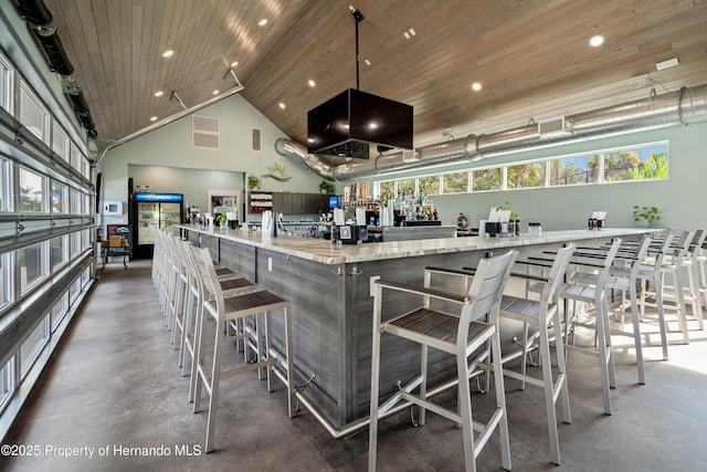 bar featuring light stone countertops, decorative light fixtures, high vaulted ceiling, and wooden ceiling