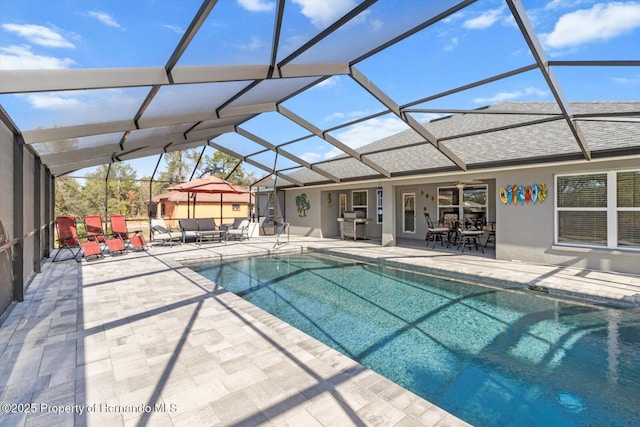 view of swimming pool with a lanai and a patio