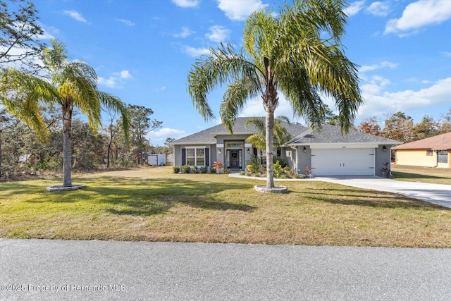 view of front of house with a front yard and a garage