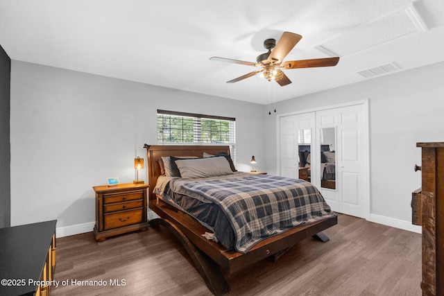 bedroom featuring dark hardwood / wood-style flooring, a closet, and ceiling fan