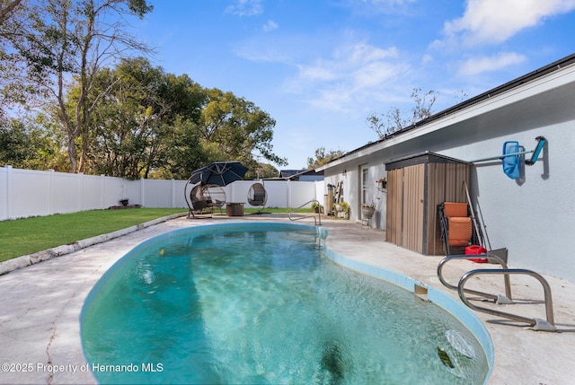 view of pool with a lawn