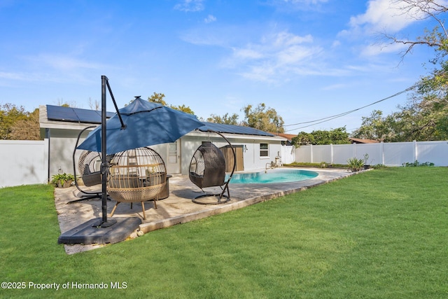 exterior space with a fenced in pool, a yard, a patio, and solar panels