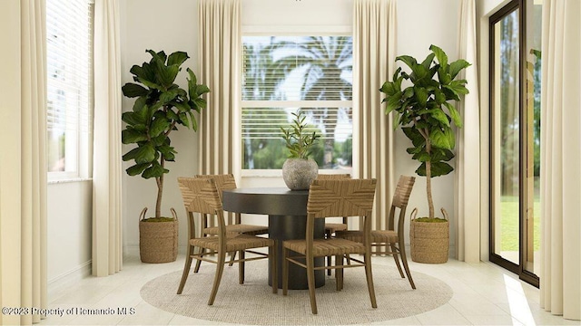 tiled dining room with a wealth of natural light