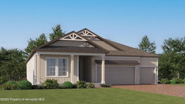 view of front of property featuring a garage and a front lawn