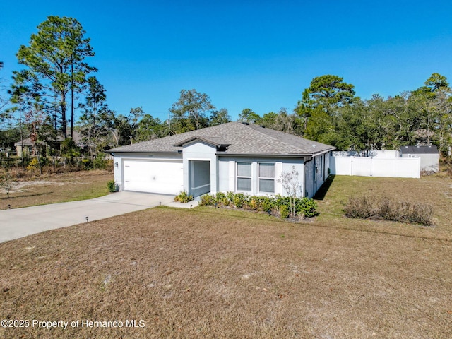 ranch-style home with a garage and a front lawn