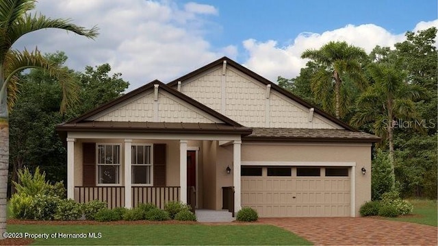 view of front of home featuring a porch and a garage