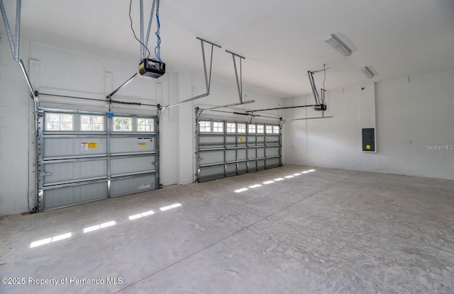 garage with electric panel and a garage door opener