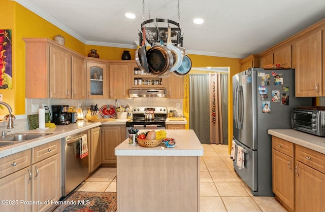 kitchen featuring a kitchen island, crown molding, appliances with stainless steel finishes, and sink