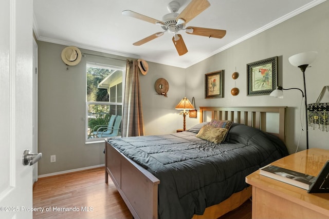 bedroom with crown molding, light hardwood / wood-style floors, and ceiling fan