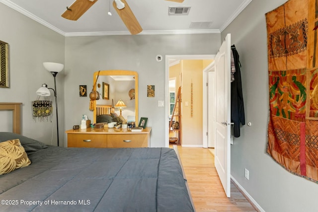 bedroom featuring light hardwood / wood-style flooring, ornamental molding, and ceiling fan