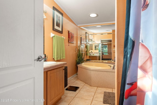 bathroom with crown molding, tile patterned floors, a bathtub, and vanity