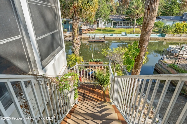 balcony featuring a dock and a water view