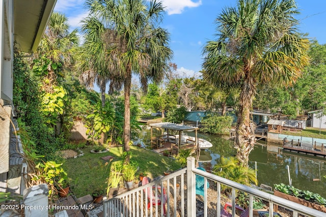 balcony featuring a boat dock and a water view