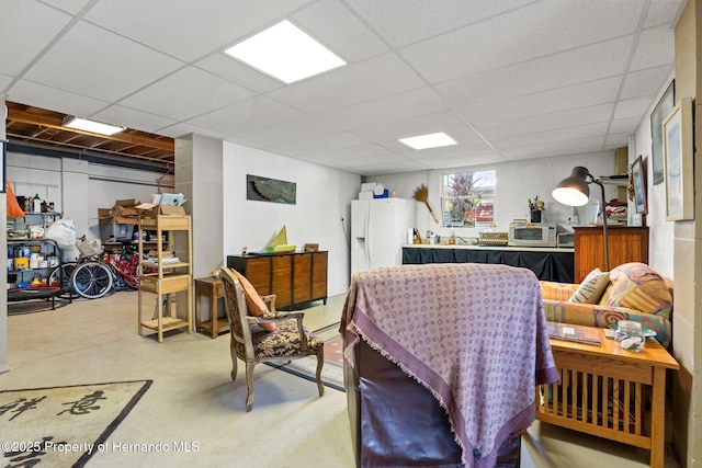 interior space with a paneled ceiling