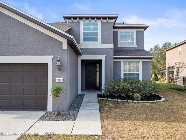 view of front of house featuring a front yard and a garage