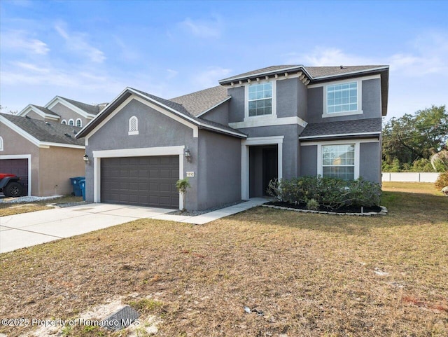 view of property with a garage and a front lawn