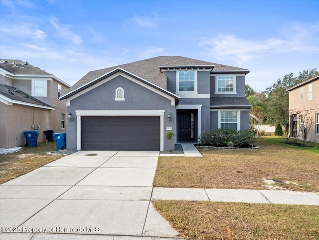 view of property with a front yard and a garage