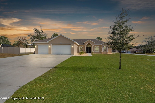 ranch-style house with a lawn and a garage