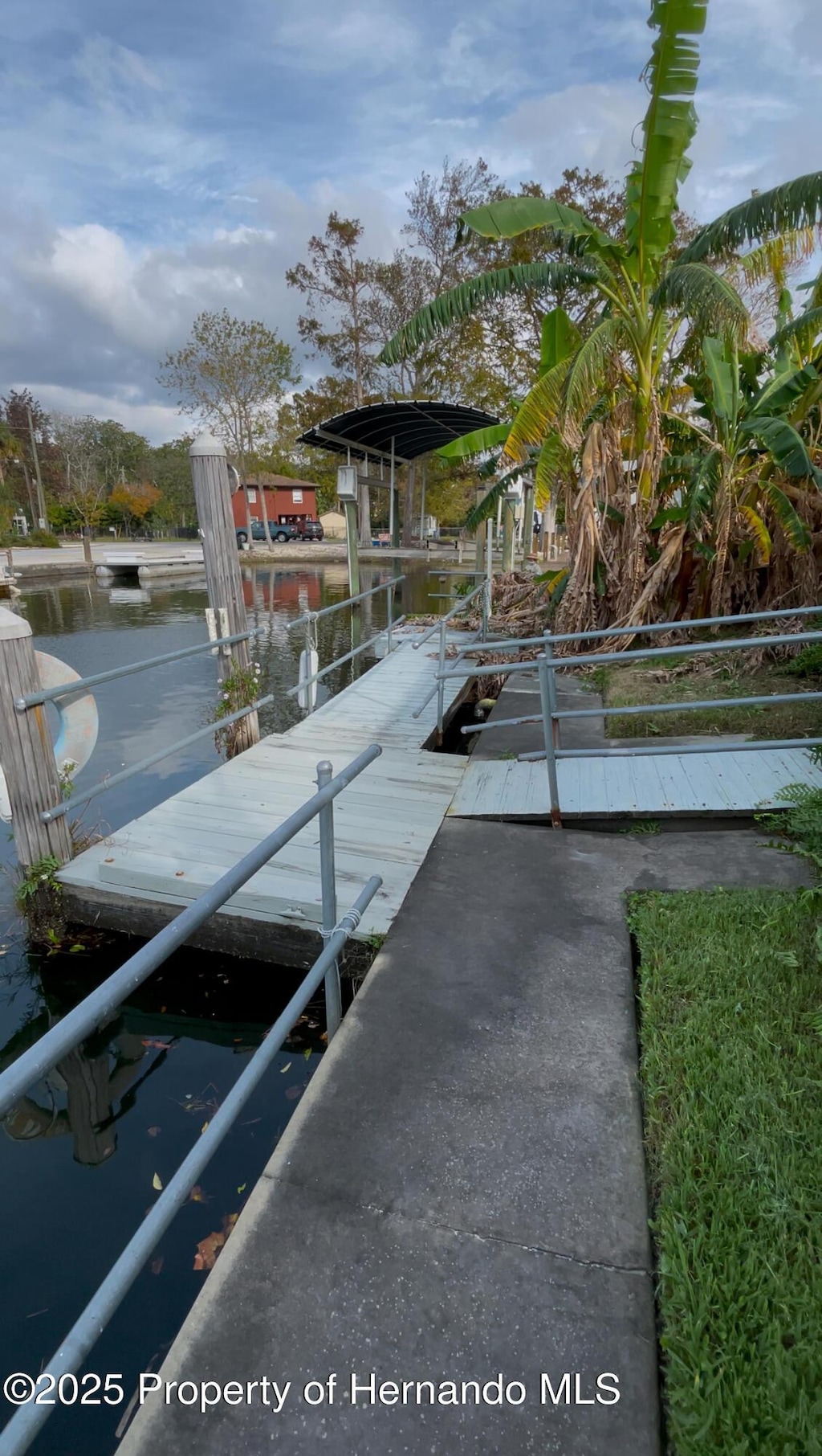 exterior space featuring a water view and a dock