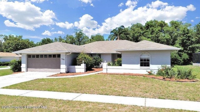 single story home featuring a front lawn and a garage