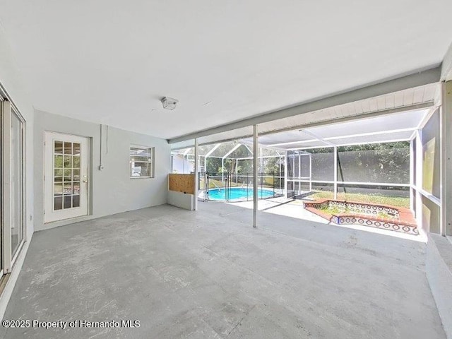 unfurnished sunroom featuring a pool