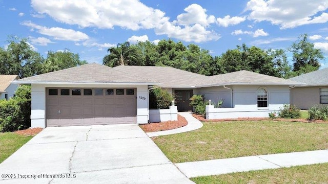 ranch-style home with a garage and a front lawn