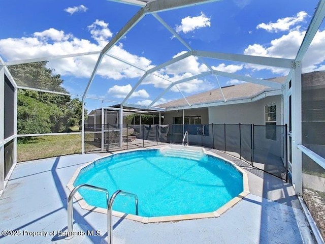 view of swimming pool featuring glass enclosure and a patio area