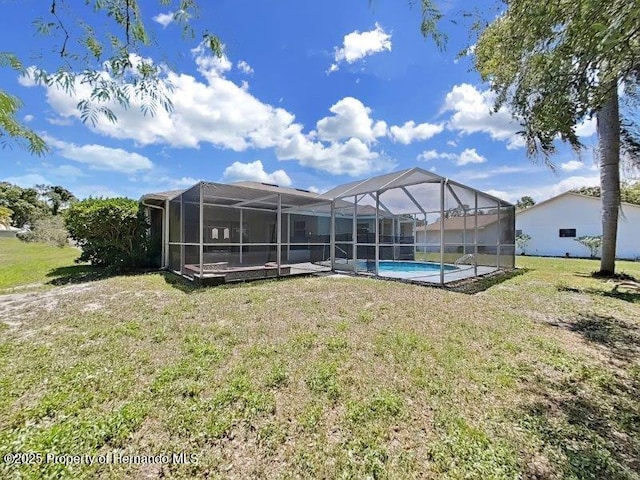 back of house with a yard and a lanai