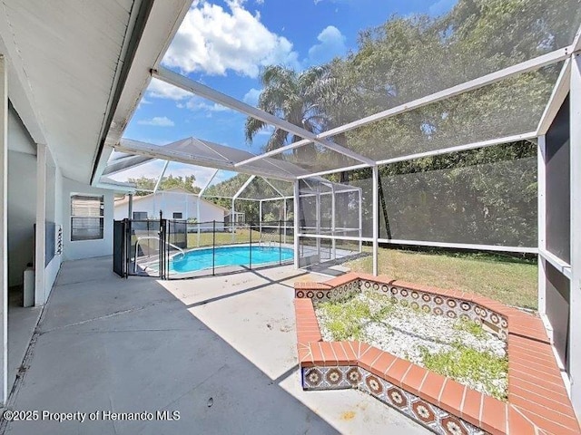 view of swimming pool featuring glass enclosure and a patio