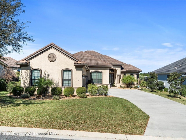 mediterranean / spanish home with a front yard