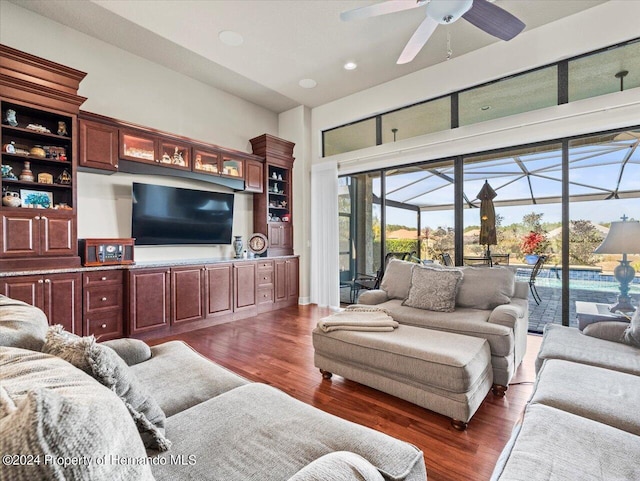 living room featuring dark hardwood / wood-style flooring and ceiling fan