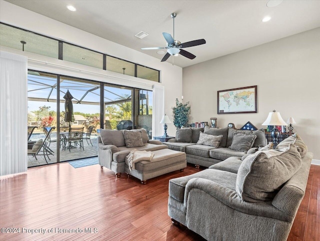 living room featuring hardwood / wood-style floors and ceiling fan