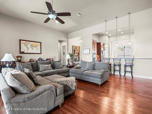 living room with dark hardwood / wood-style flooring and ceiling fan